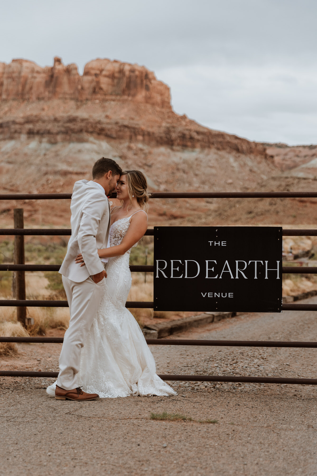 bride and groom kissing at the red earth venue in moab utah