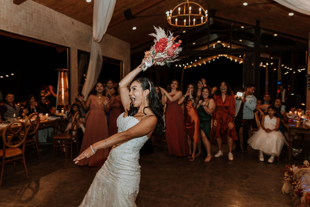 bouquet toss at a wedding at the red earth venue in moab utah