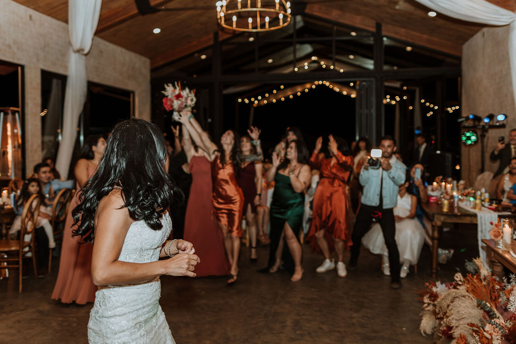 bouquet toss at a wedding at the red earth venue in moab utah