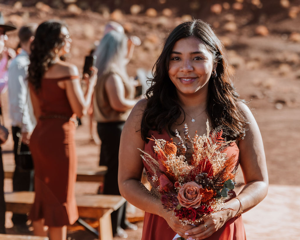bridesmaids walking down the isle at the red earth venue in moab utah
