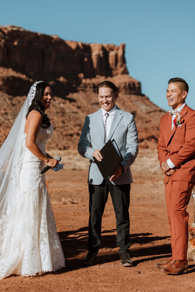 groom laughing at a wedding in the desert