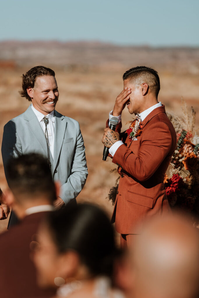 groom crying at a wedding in the desert