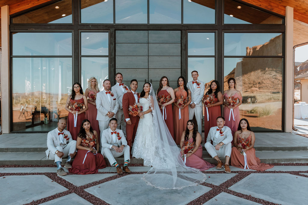 large bridal party photo at the red earth venue in moab utah