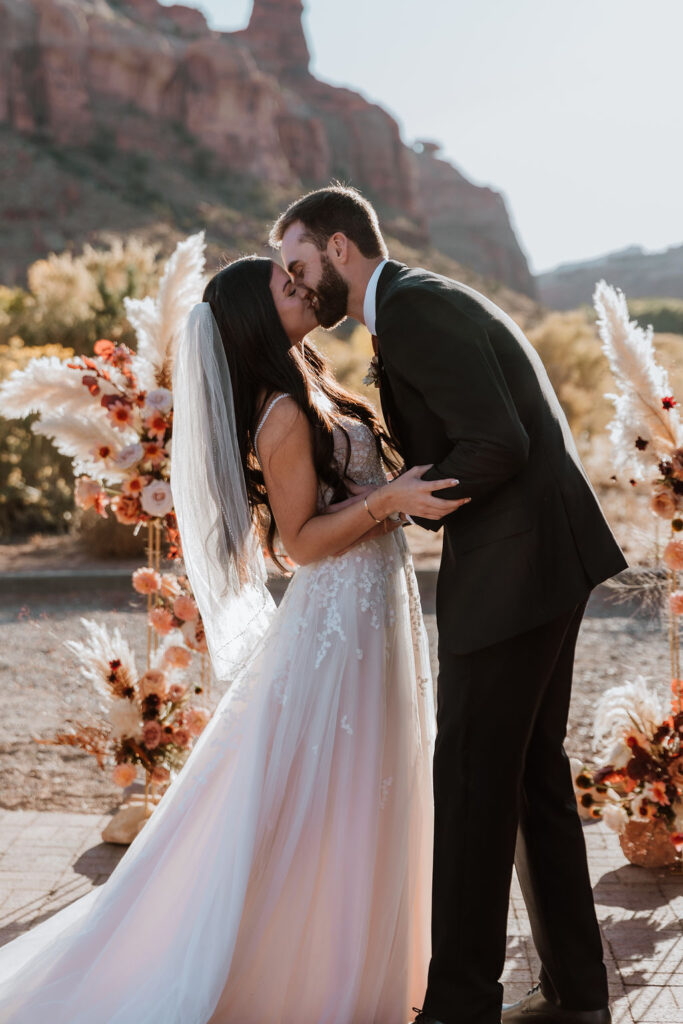 couple kisses at The Red Earth Venue in Moab