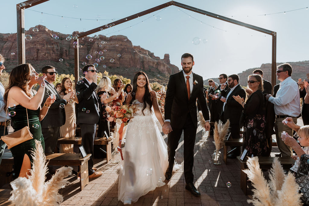 couple exits wedding through bubbles 