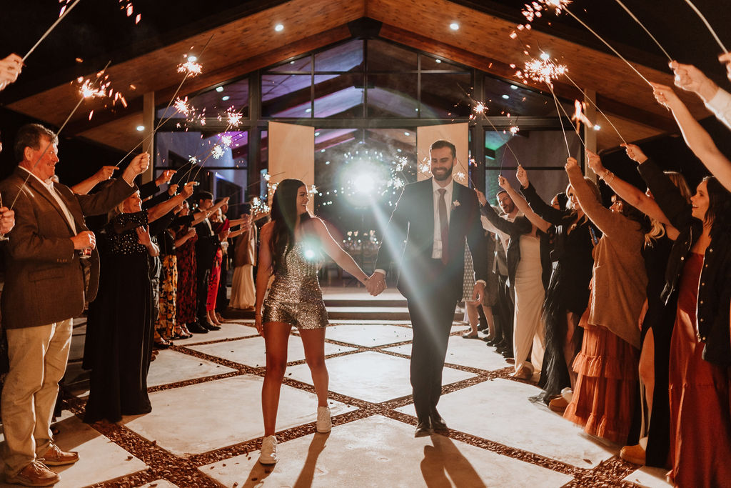 couple walks holding hands under sparkler exit 