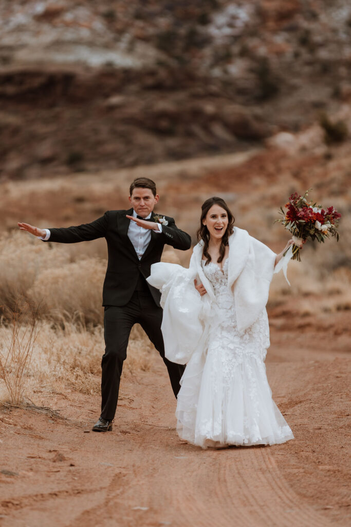 couple dances together at outdoor winter wedding in Moab