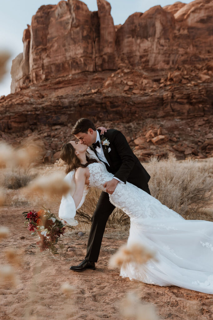couple kisses at outdoor winter wedding in Moab