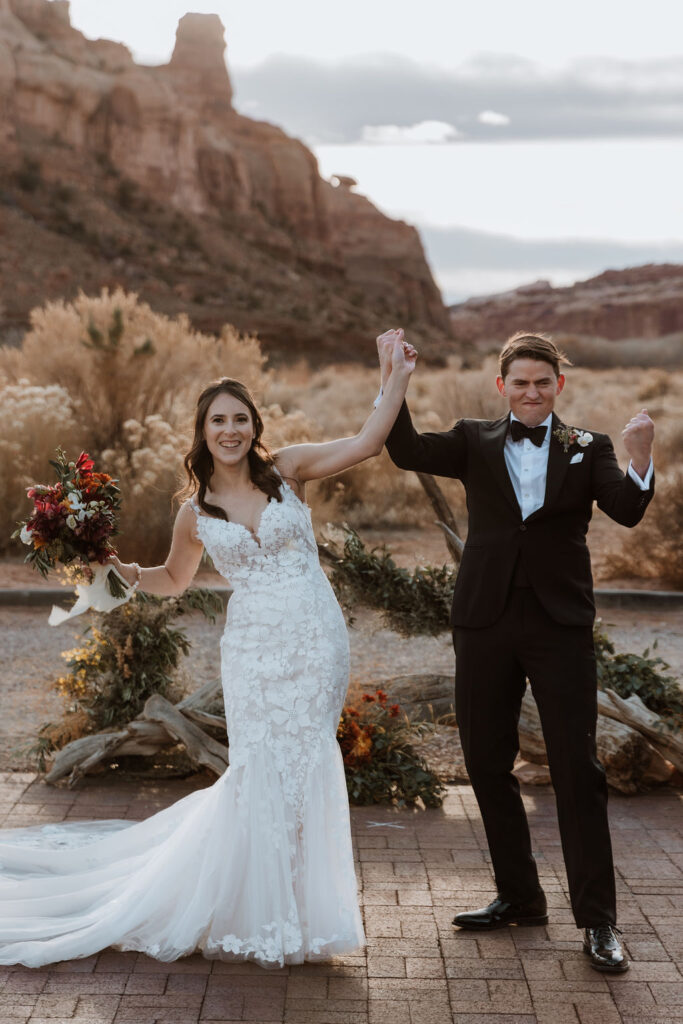 couple holds hands at The Red Earth Venue Moab 