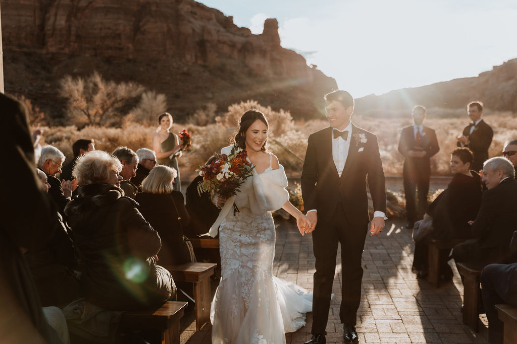 couple walks holding hands at Red Earth Venue wedding venue