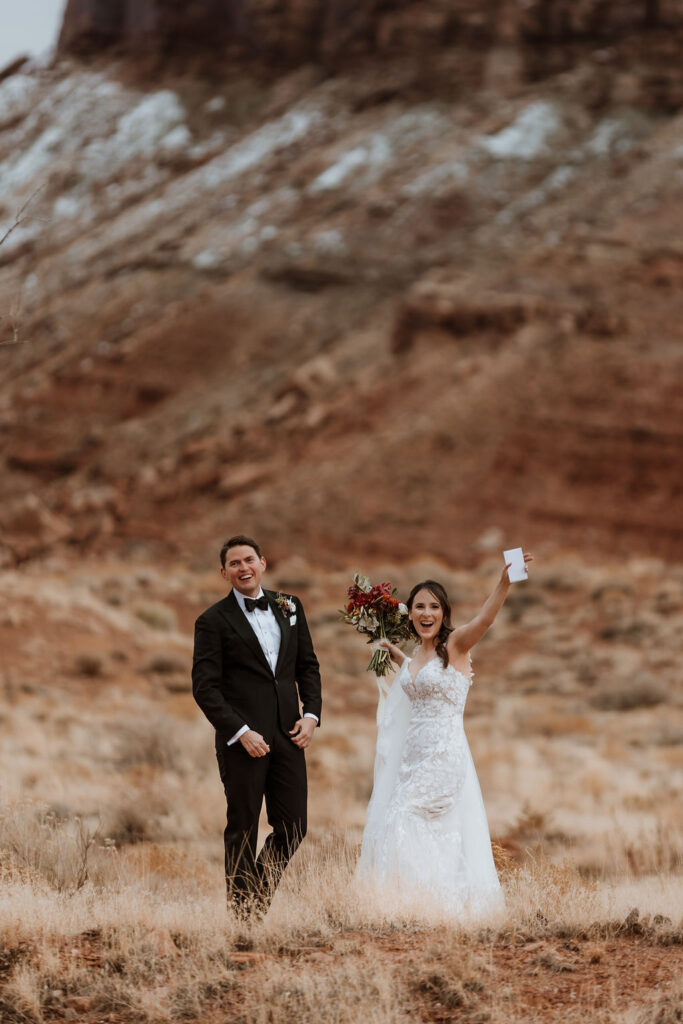 couple exchanges vows at outdoor winter wedding in Moab