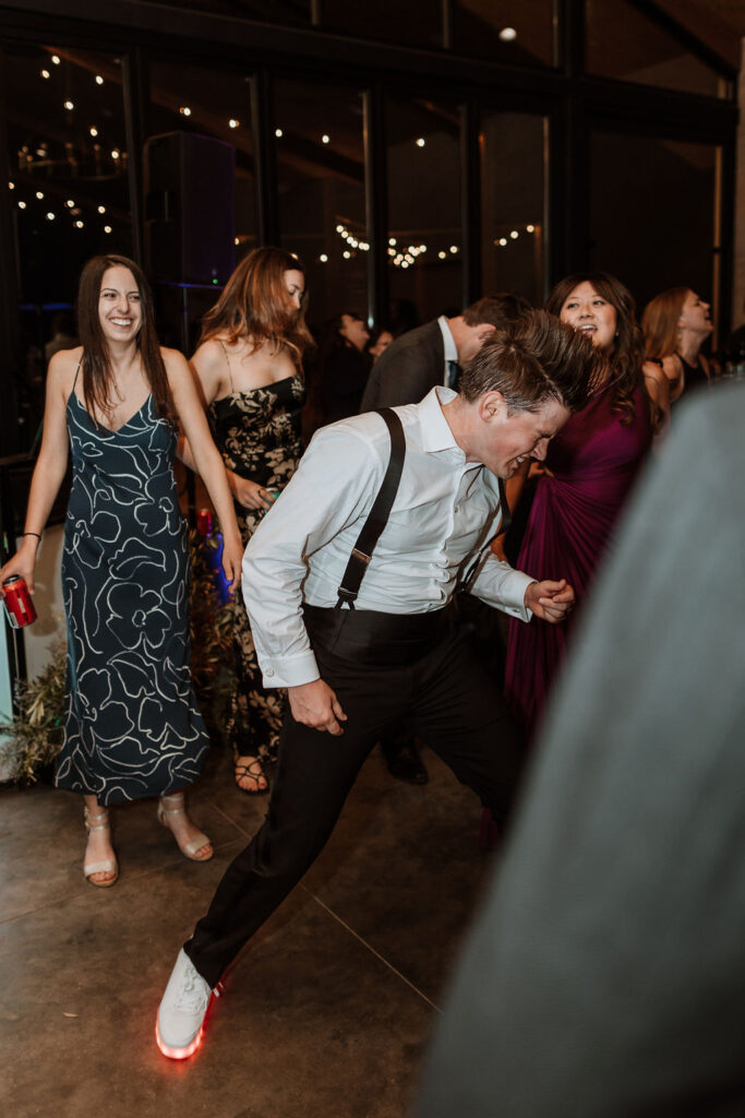 groom dances at wedding reception