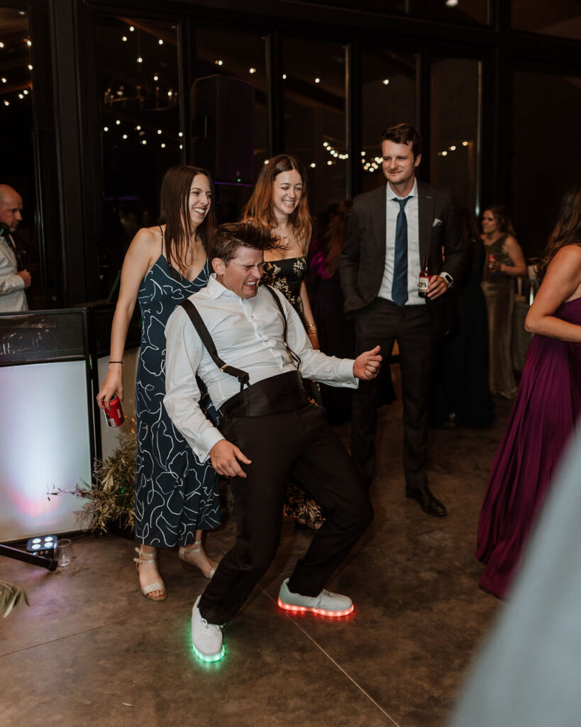 groom dances at wedding reception