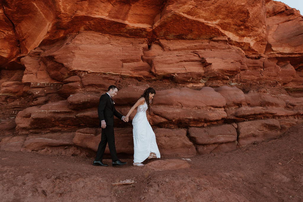 couple walks along moab utah desert red rock