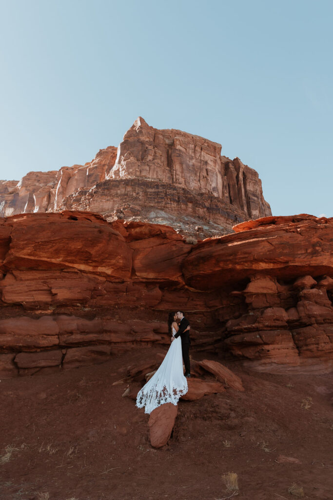couple stands on moab utah desert red rock