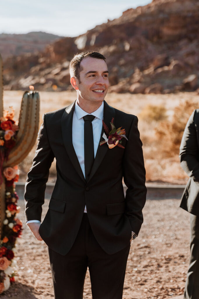 groom watches bride walk down aisle at the red earth venue wedding