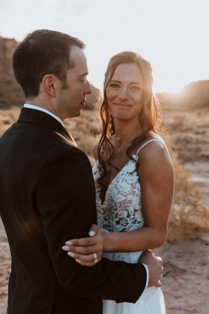 couple embraces at Moab sunset elopement