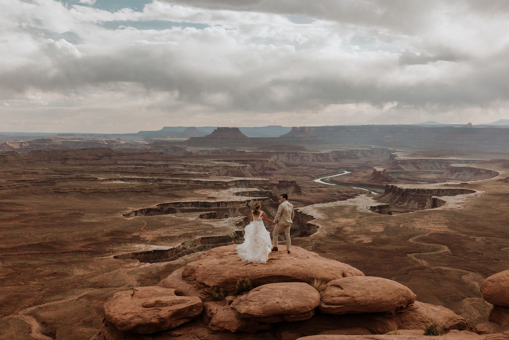 couple holds hands at Green River Overlook elopement