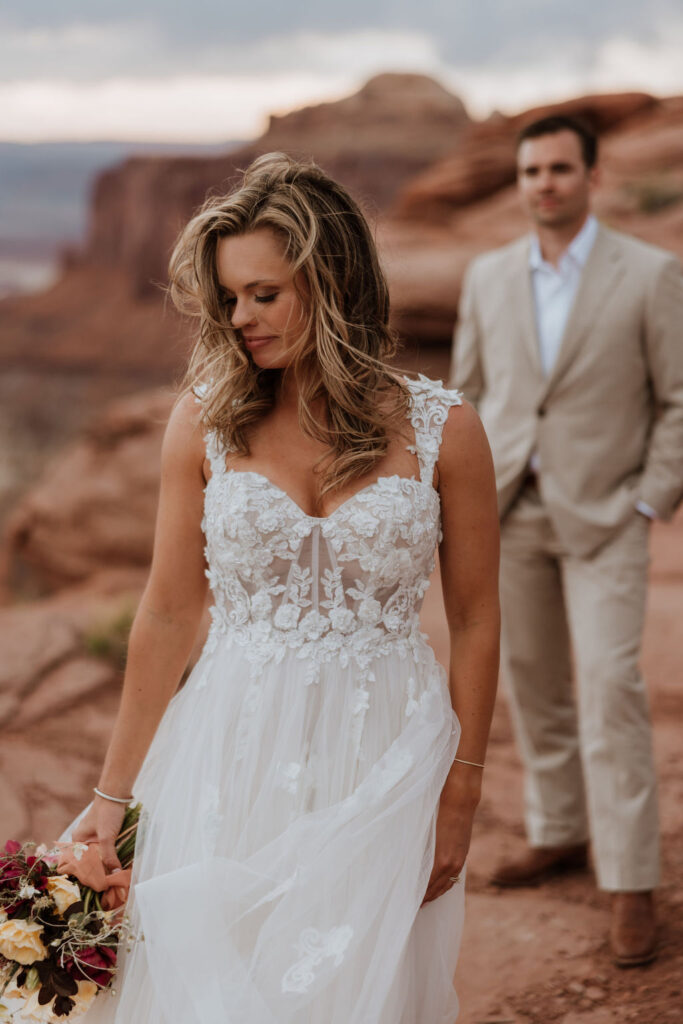bride holds wedding flowers at red rock elopement
