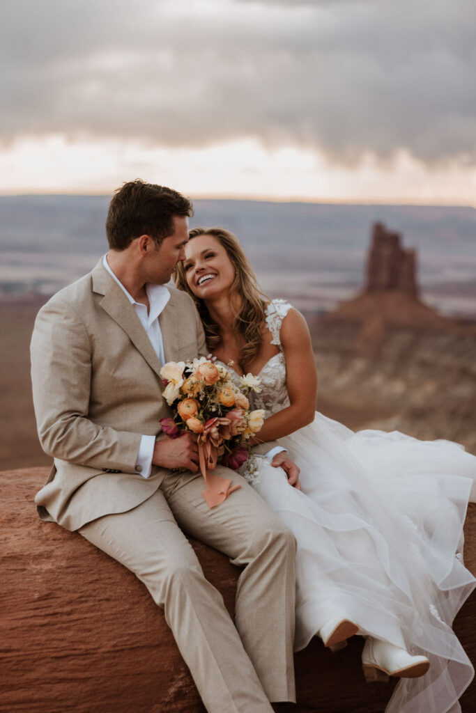 couple embraces at Moab sunset elopement