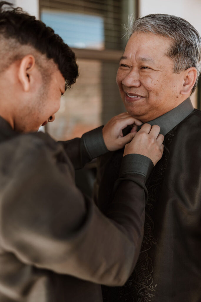 groom ties dad's tie on wedding day