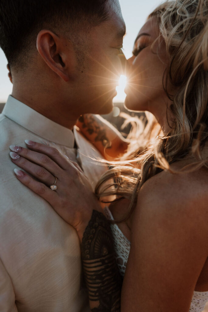 couple kisses at sunset elopement