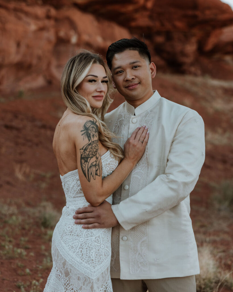 couple embraces at Moab desert elopement