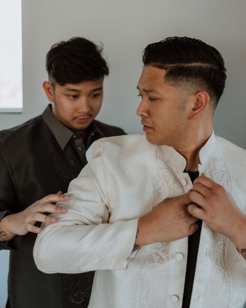 groom gets dressed with groomsmen