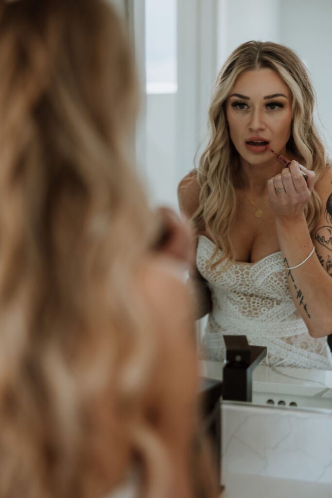 wedding getting ready photos of bride putting on makeup