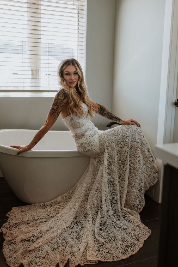 bridal portraits of bride sitting on tub