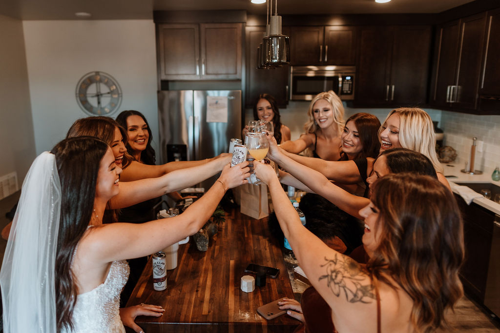 bride cheers with bridesmaids