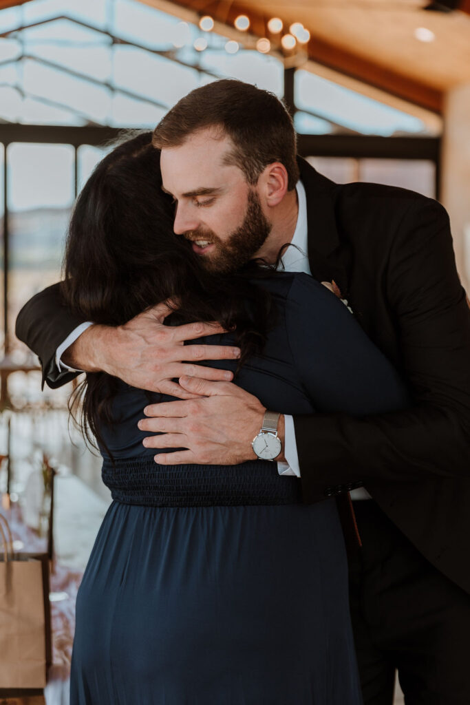 groom hugs mom on wedding day