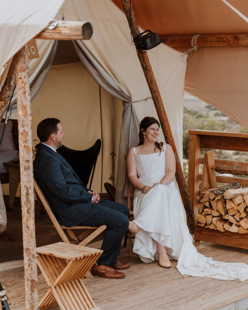 couple sits at Under Canvas Moab tent