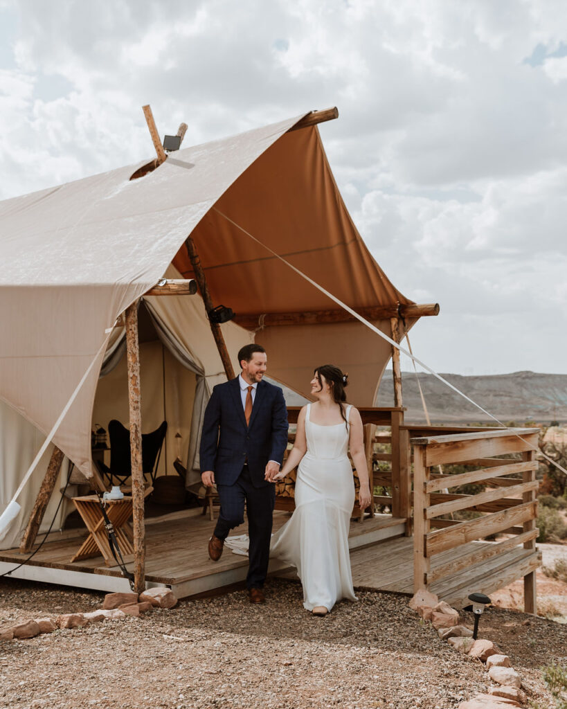 couple walks at Under Canvas Moab tent