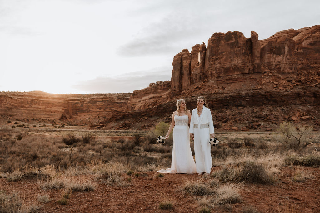 couple holds hands at Moab sunset elopment