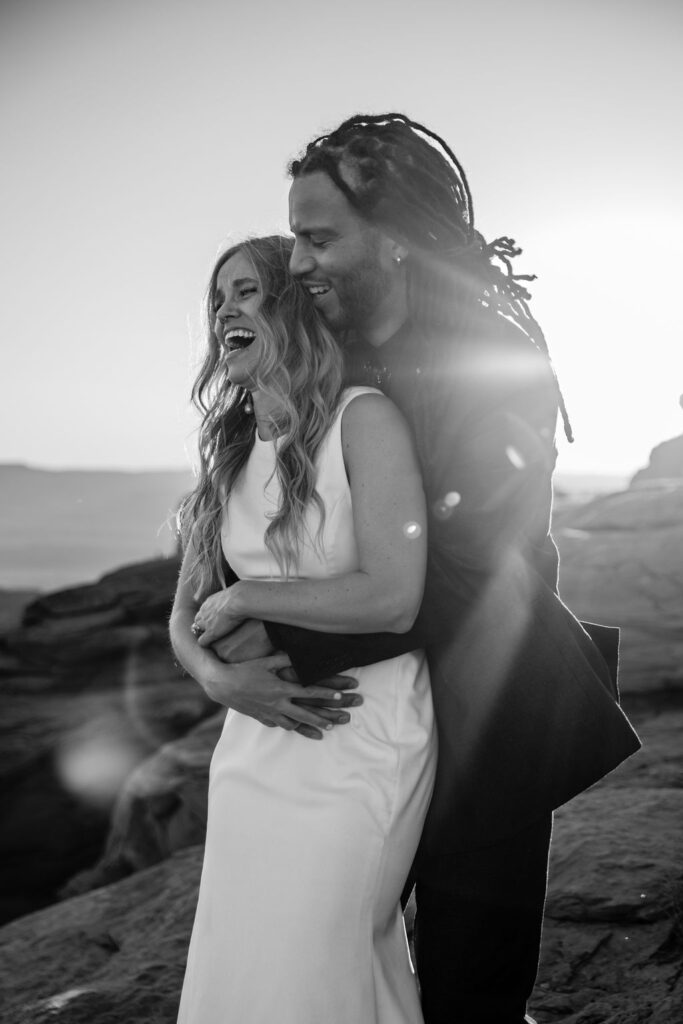 groom embraces bride at Moab couples adventure