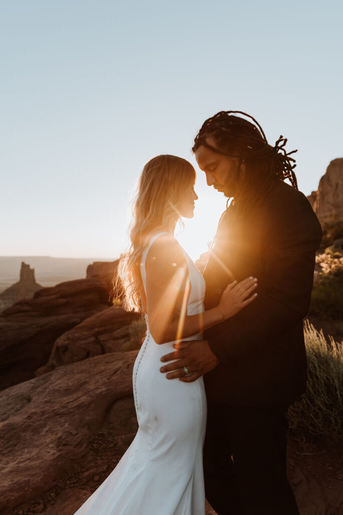 couple kisses at Moab sunset desert elopement