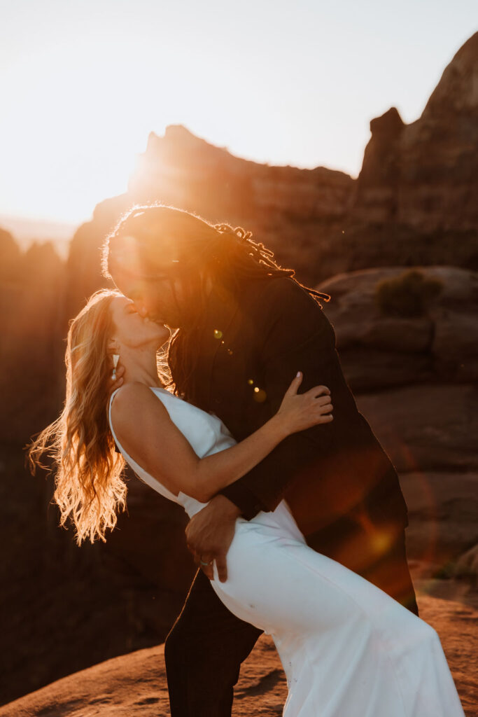 couple embraces at Moab sunset desert elopement