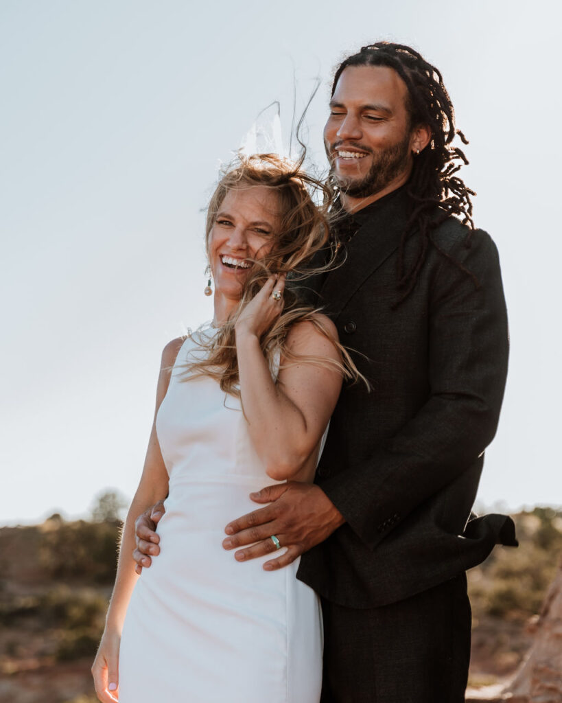 couple laughs together at Moab desert elopement