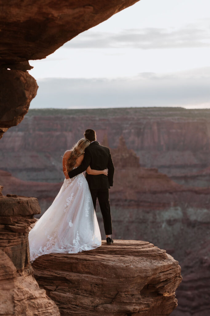 couple poses at Dead Horse Point Overlook