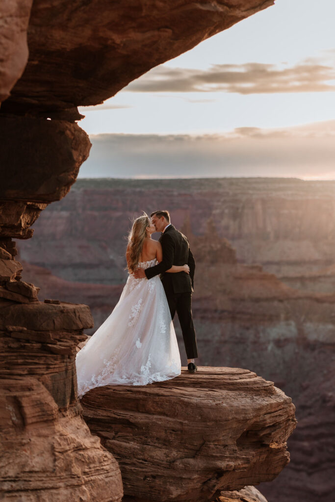 couple kisses at Dead Horse Point Overlook