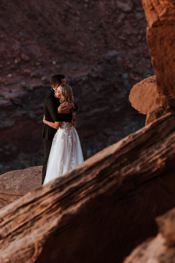 couple embraces at Dead Horse Point Overlook
