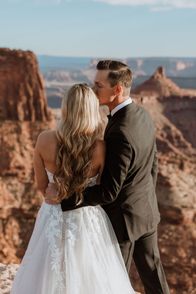 couple kisses at Moab sunset elopement 