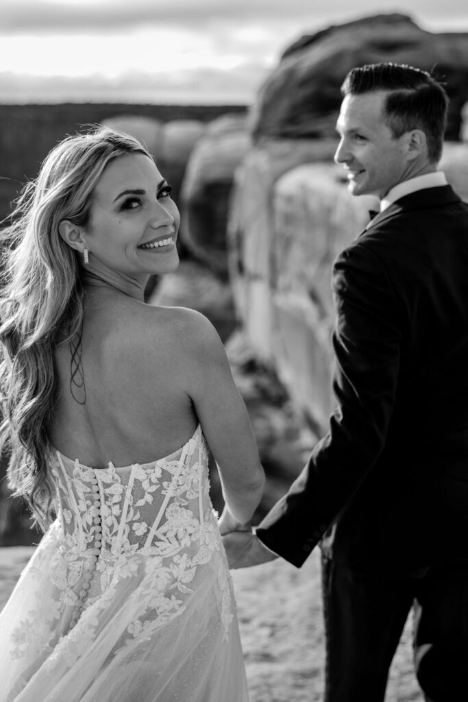 couple holds hands at Moab sunset elopement 