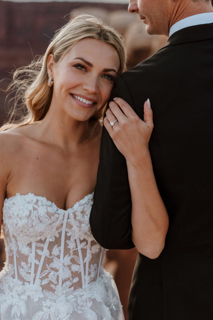 couple embraces at Moab sunset elopement