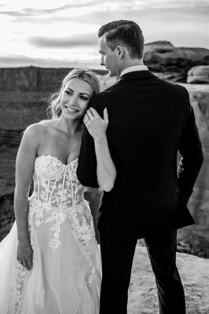 couple embraces at Moab sunset elopement 