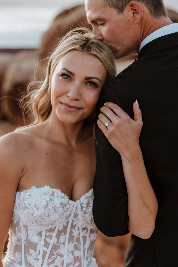 couple embraces at Moab sunset elopement