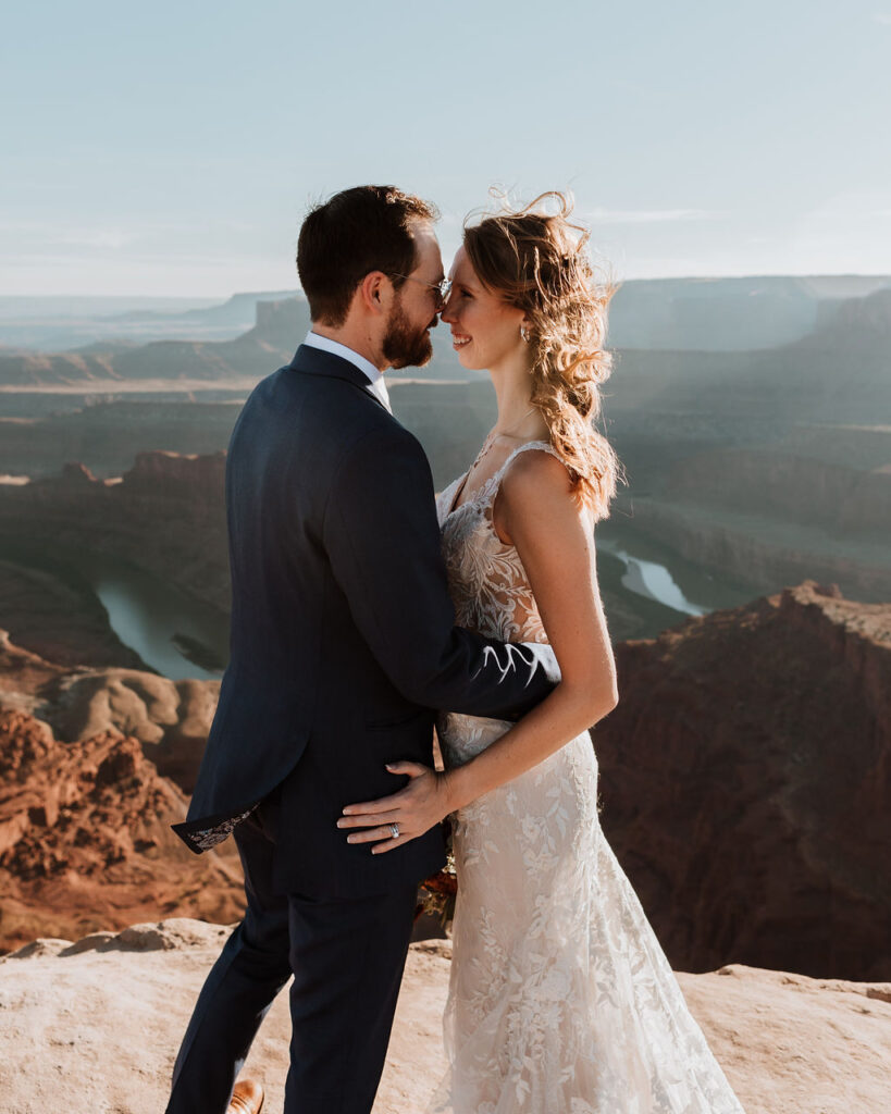 couple embraces on top of Moab overlook