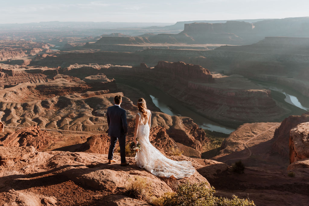 couple holds hands at Dead Horse Point State Park Moab elopement 