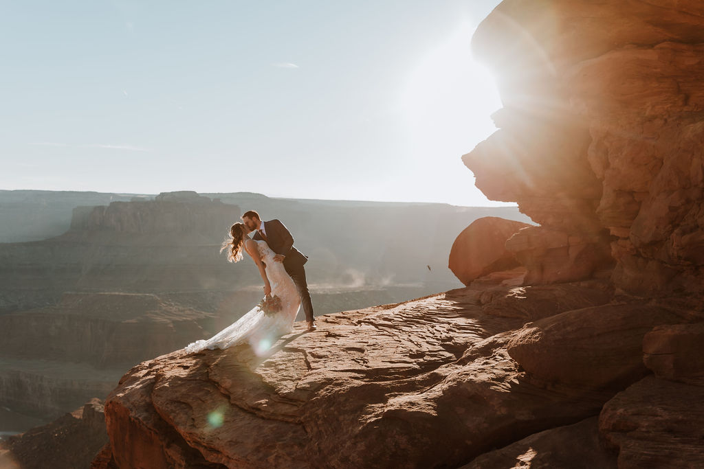 couple kisses at sunset Moab elopement